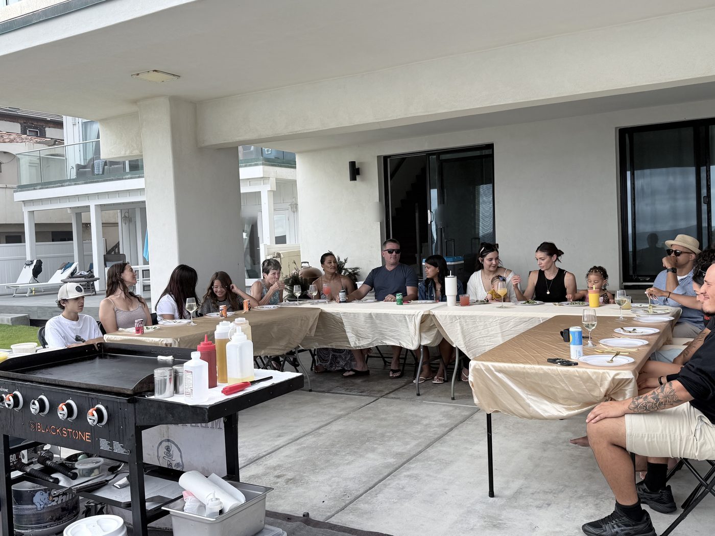 Guests enjoying a casual hibachi dinner at home