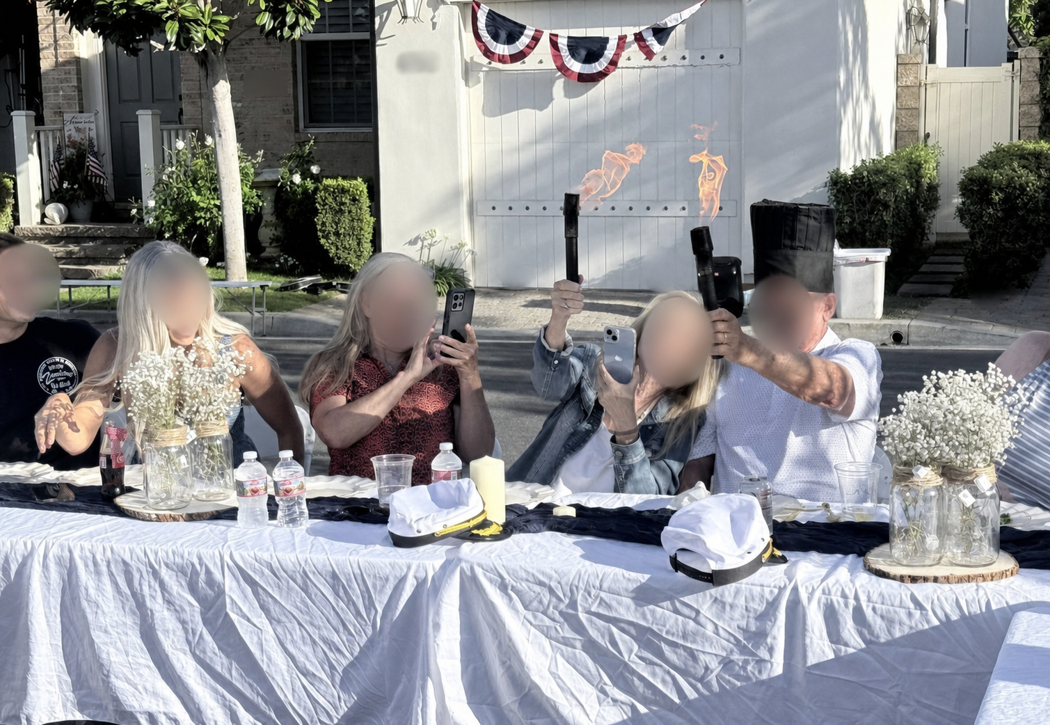 Party guests filming a fun hibachi fire moment together